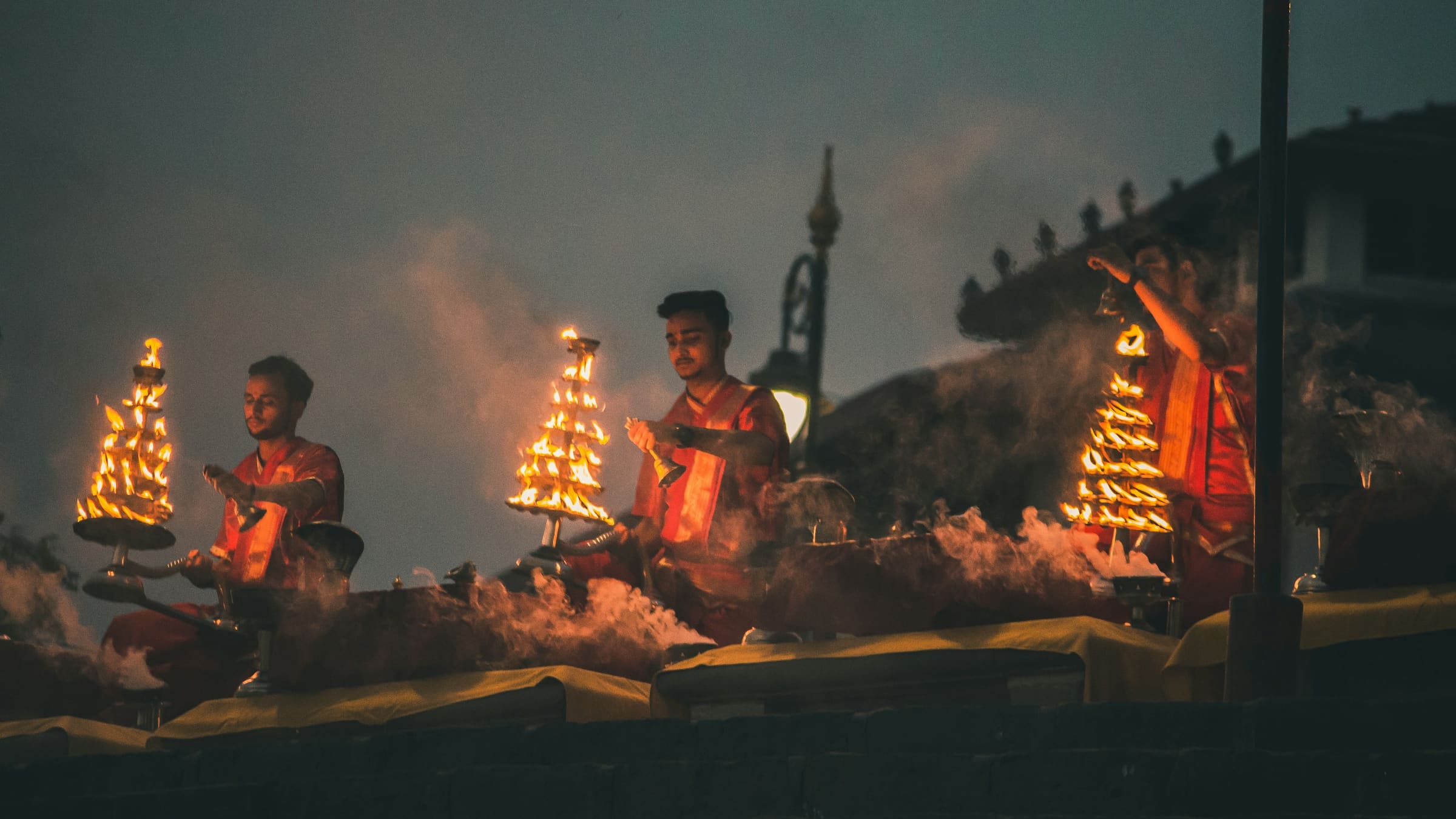 Varanasi Ganga Aarti audio tour Priests performing the evening Ganga Aarti with brass lamps on the Varanasi ghats